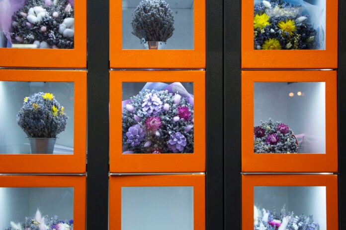 photo-of-vending-machine-with-orange-compartments-selling-bouquets-of-flowers