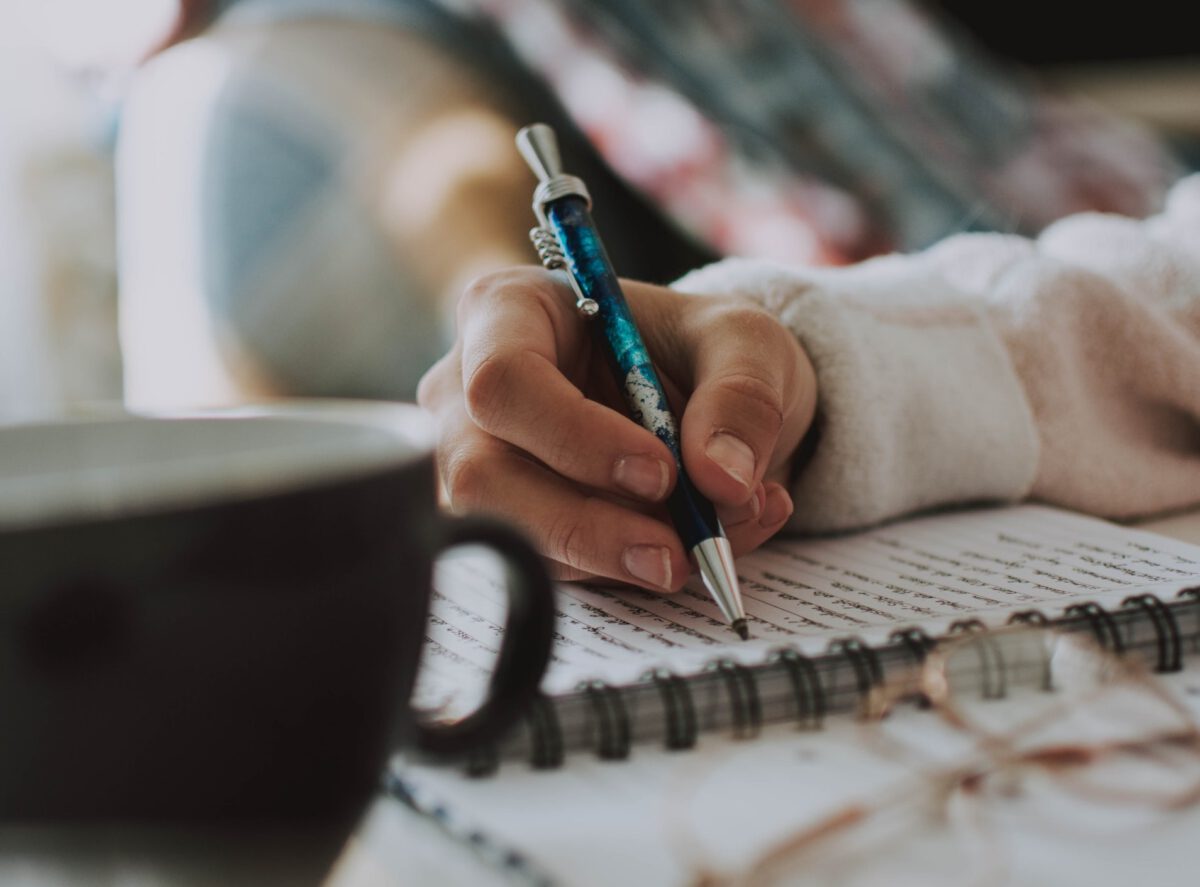 Photo-of-person-journaling-with-cup-of-coffee