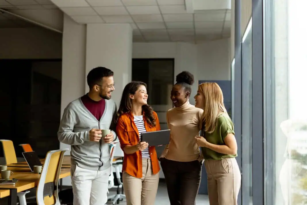 four young colleagues talking to each other at a dutch office