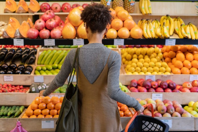 back-view-woman-shopping-for-fruit-and-vegetables-in-a-dutch-supermarket