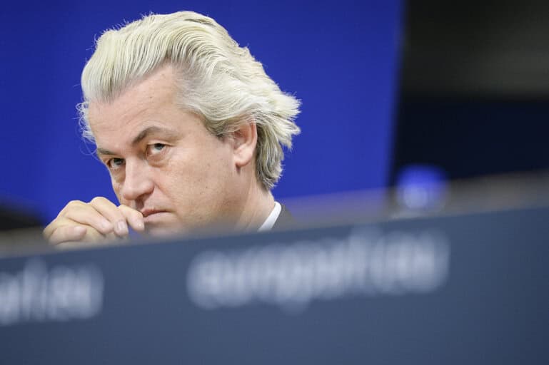 photo-of-geert-wilders-with-head-tilted-down-hand-near-mouth-with-blue-background-at-european-conference