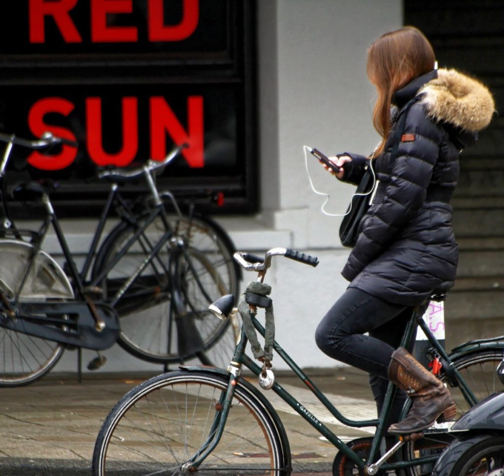 Girl on bike using phone