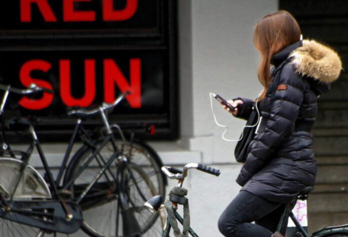 Girl on bike using phone