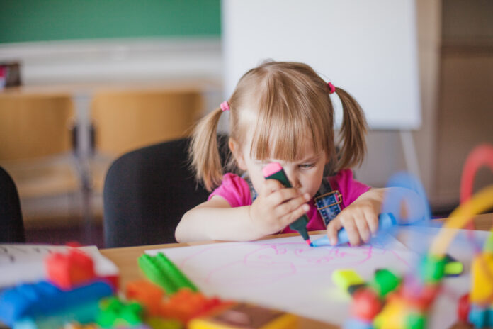 photo-of-a-girl-drawing-in-kindergarden