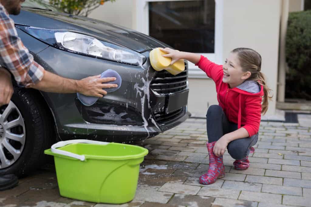 photo-of-girl-helping-father-clean-the-car-to-earn-some-pocket-money-in-the-netherlands