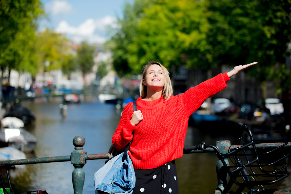 a-picture-of-a-girl-in-a-red-sweater-enjoying-the-sun-in-Amsterdam