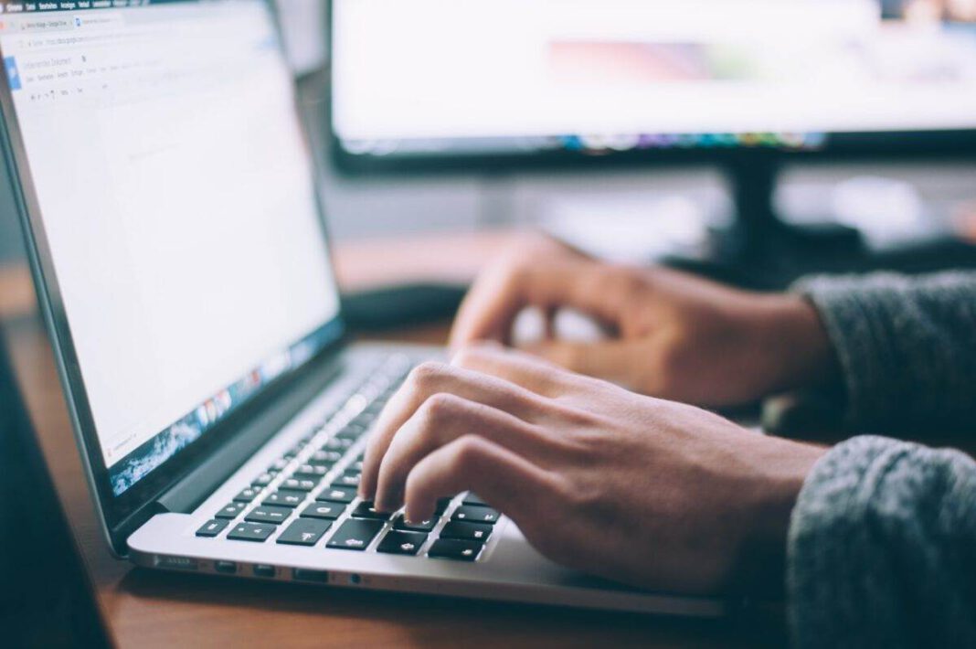 An-official-at-a-Dutch-municiplality-using-a-fake-scoial-media-account-on-a-laptop