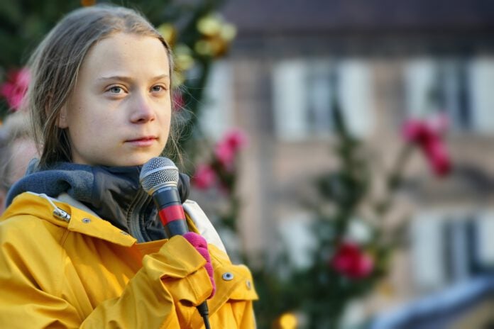photo-of-climate-activist-greta-thunberg-with-microphone-speaking-at-protest