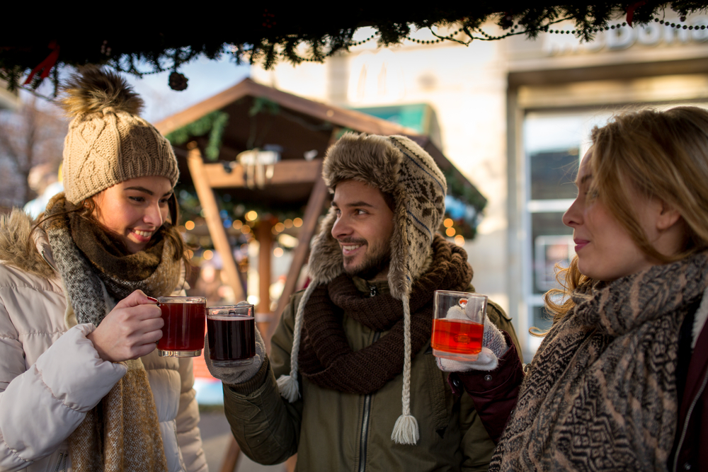 group-of-friends-drinking-mulled-wine-at-a-christmas-market