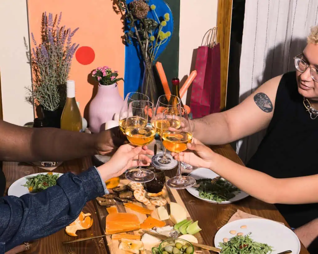 photo-of-group-of-gender-diverse-friends-celebratingat-a-borrel