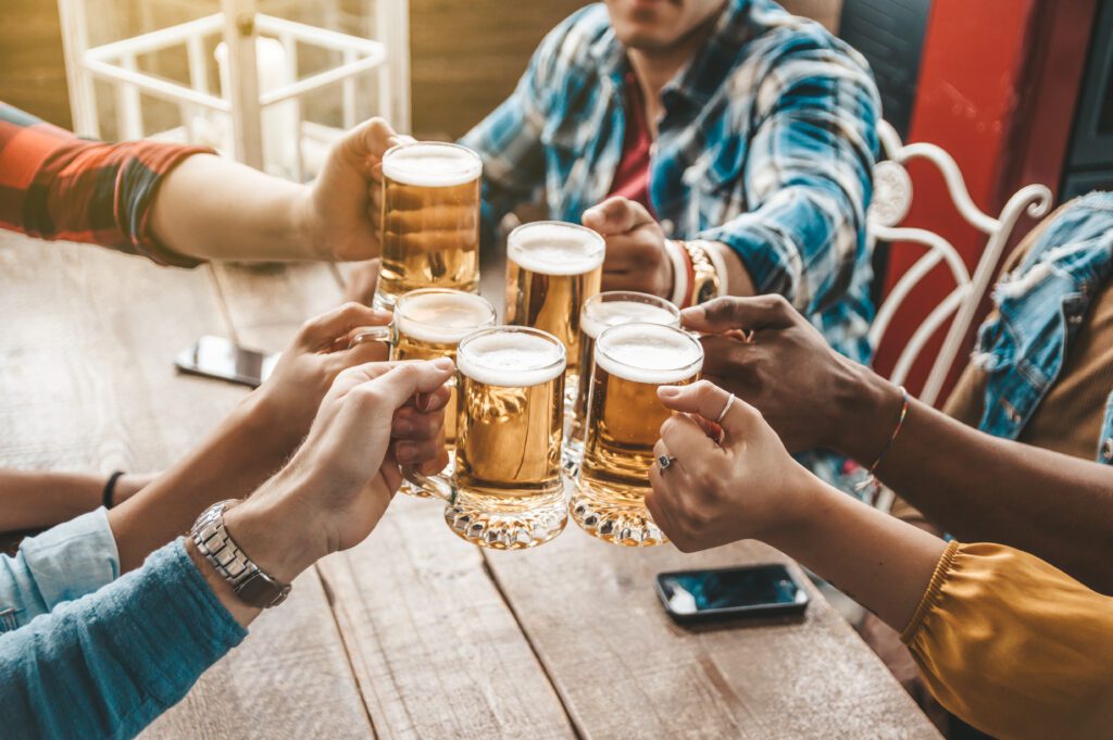 photo-of-group-of-friends-toasting-with-beer-in-a-pub-in-the-netherlands