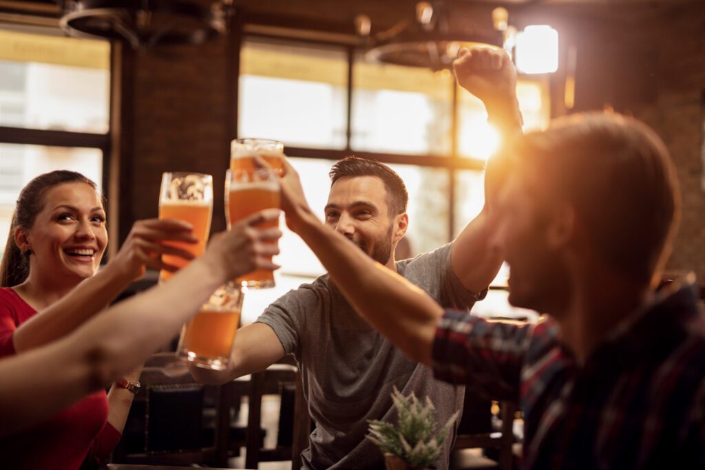 group-of-young-people-celebrating-kings-day-drinking-lots-of-beer-at-pub