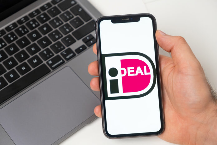 photo-of-hand-holding-phone-with-ideal-online-payment-company-logo-on-screen