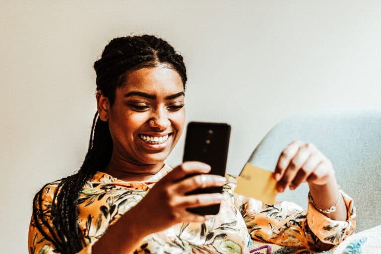 happy-young-woman-smiling-at-phone-making-a-purchase-with-ING-bank-card