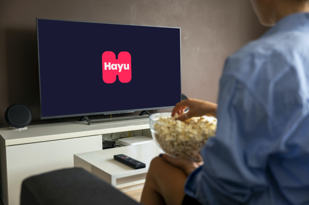 photo-person-eating-popcorn-while-opening-hayu-on-flatscreen-tv