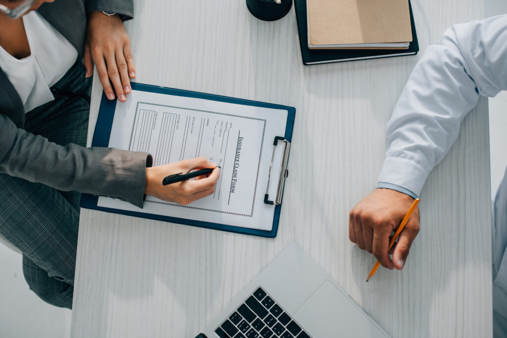 Woman-about-to-sign-a-health-insurance-form-before-registering-with-a-doctor-in-the-netherlands