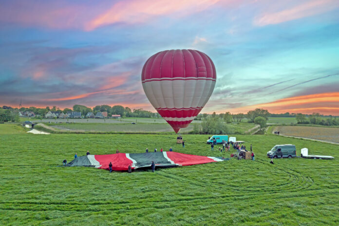 hot-air-balloon-taking-off-from-field-in-dutch-countryside