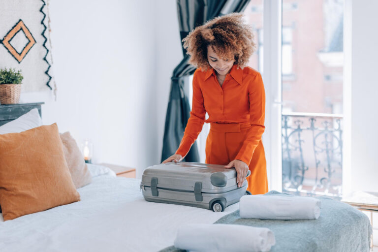 photo-of-woman-unpacking-suitcase-at-hotel-in-amsterdam