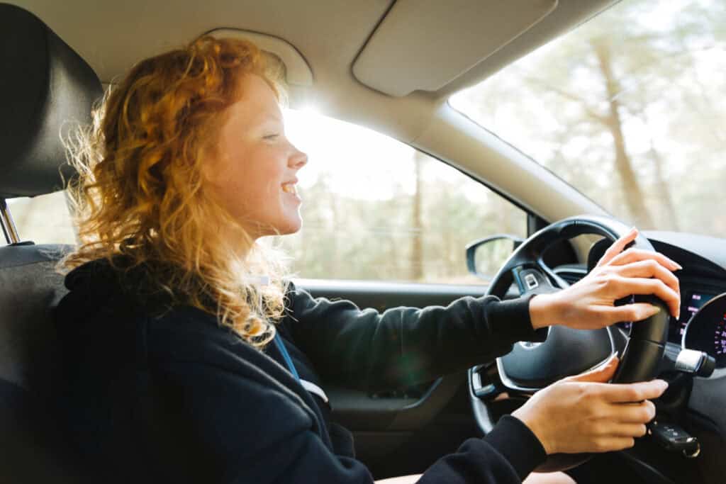 photo-of-woman-behind-wheel-of-car-driving-in-the-Netherlands-after-passing-driving-theory-exam