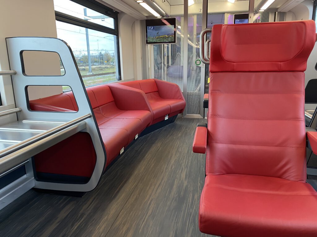 New intercity interior photo from the first class. We see a lounge sofa and regular seats in red