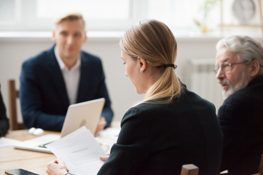 photo-of-employee-and-lawyers-sitting-at-table-looking-at-papers-fighting-instant-dismissal-in-the-Netherlands