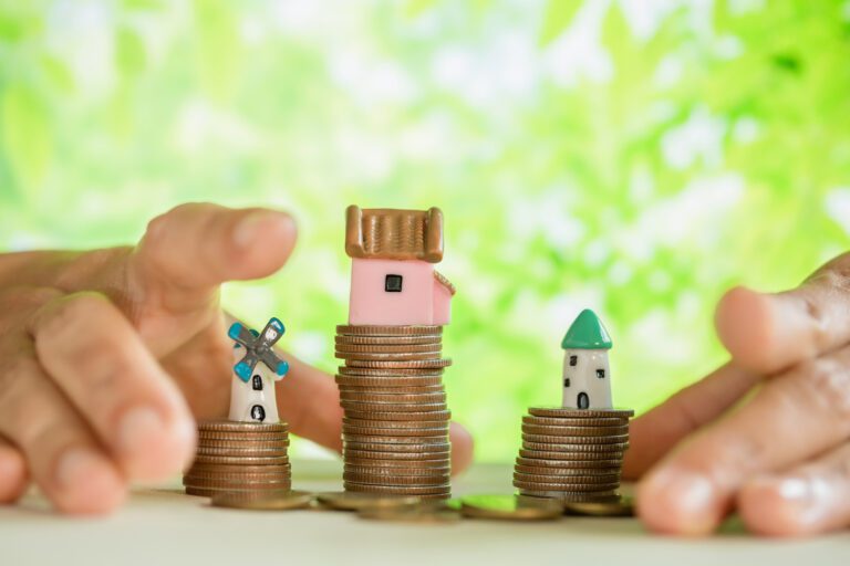 photo-of-coins-stacked-and-small-ceramic-houses-placed-on-top-representing-interest-rates-in-the-netherlands