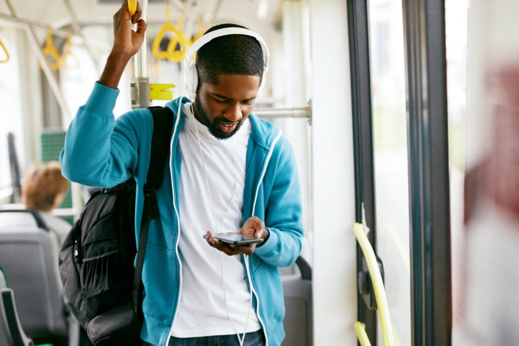 man-listening-to-music-on-dutch-bus-thanks-to-the-esim-loaded-on-his-mobile-phone