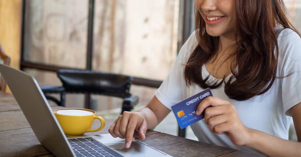 photo-young-woman-completing-online-international-money-transfer-using-credit-card