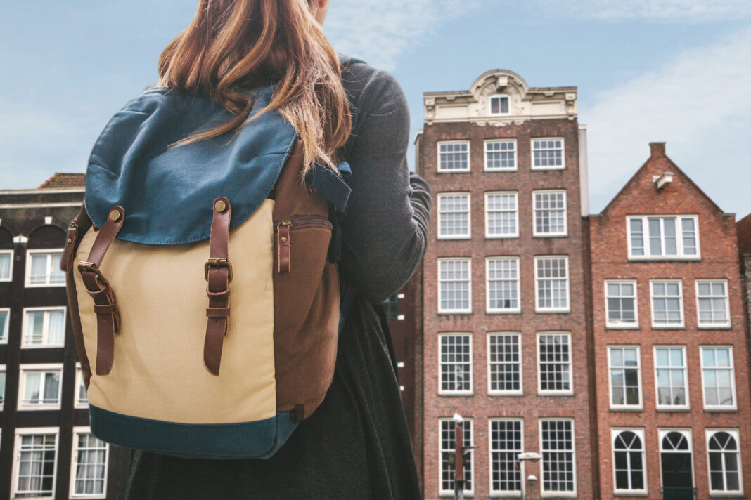 photo-of-girl-with-backpack-in-front-of-dutch-houses