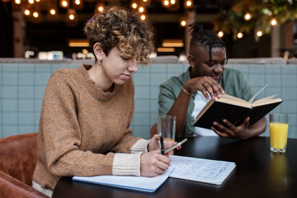 international-students-in-the-netherlands-who-need-dutch-health-insurance-studying-in-a-cafe