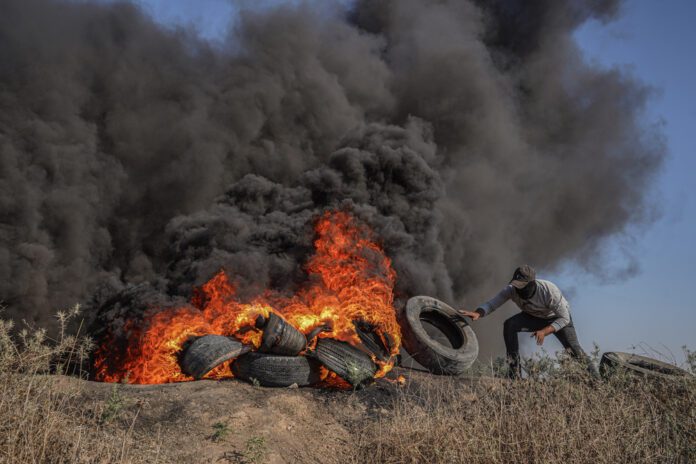 Palestinian-youth-set-fire-to-rubber-tires-on-the-gaza-strip