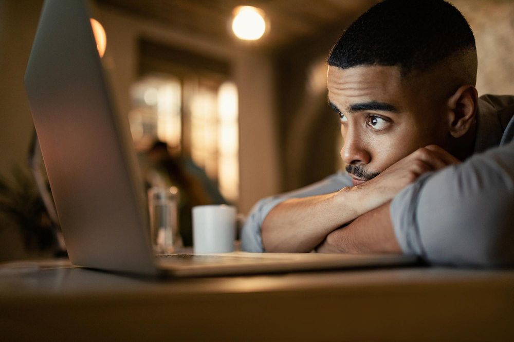 photo-of-man-looking-at-computer-looking-tired