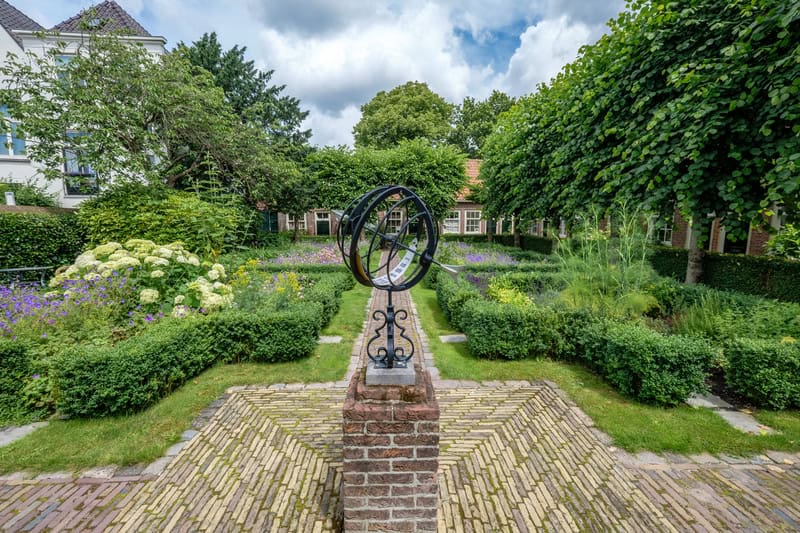 photo-of-lush-garden-courtyard-klaeuwshofje-in-delft-netherlands.