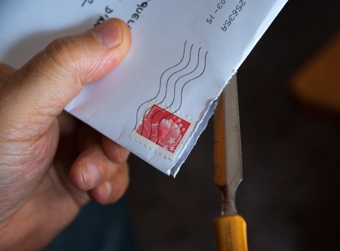 Person-holding-a-letter-from-the-mail