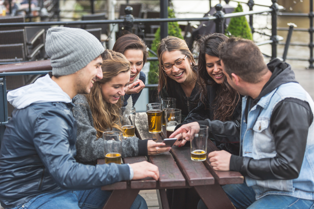 group-of-international-friends-drinking-beer-and-laughing