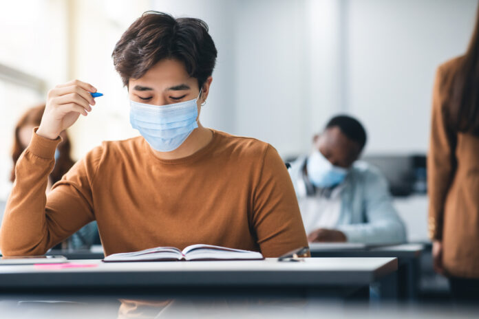 male-student-taking-exam-with-mask-on