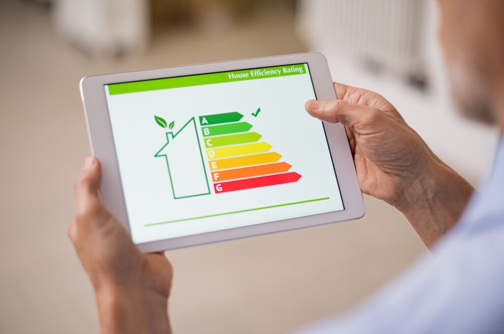 man-checking-energy-efficiency-of-house-in-the-netherlands-on-tablet