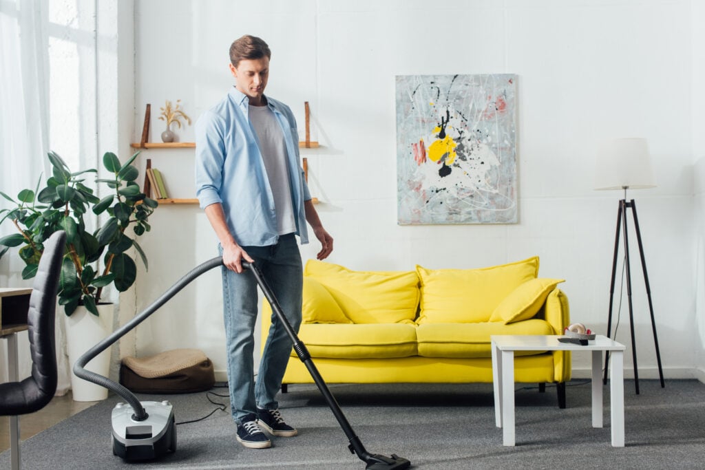 man-high-on-hash-in-amsterdam-cleaning-his-home-with-vacuum-cleaner