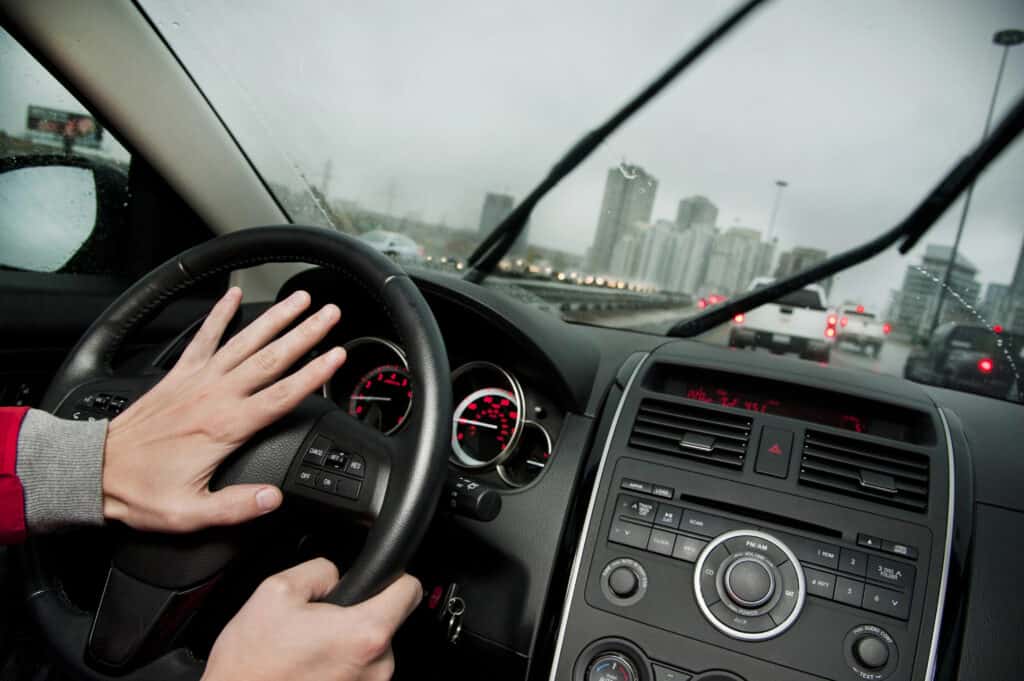 photo-of-person-honking-inside-car-traffic-bad-weather-on-road