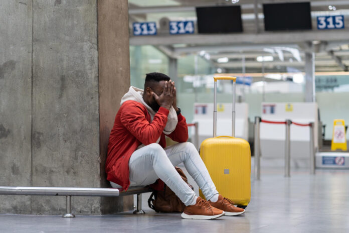 photo-of-man-upset-in-airport-after-cancelled-flight