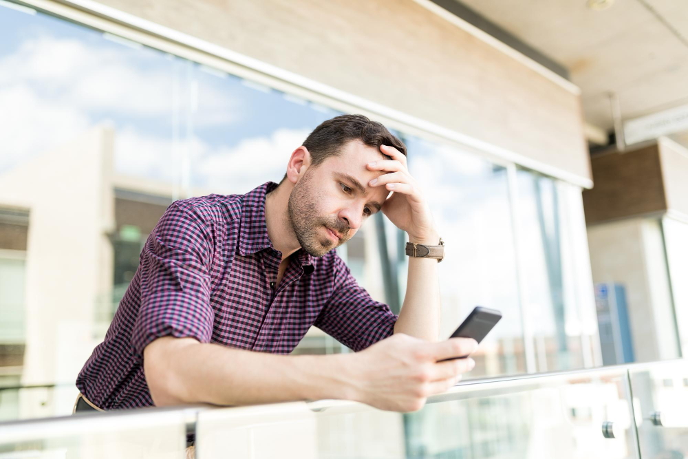 photo-of-man-looking-stressed-at-phone