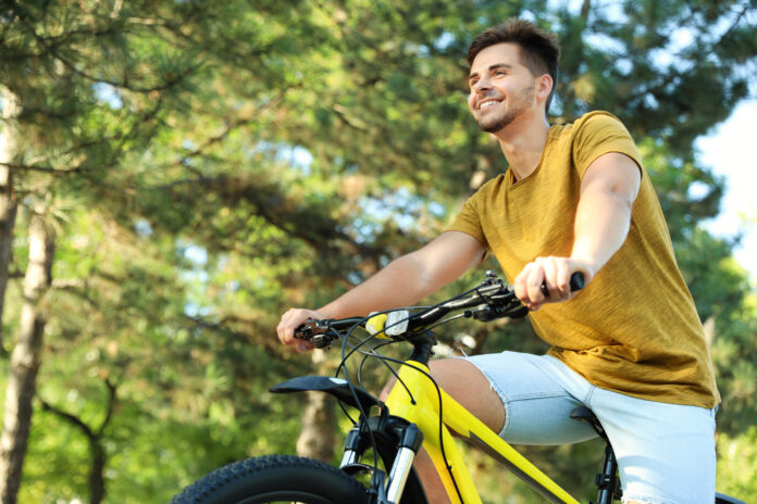 photo-of-young-man-riding-bike-in-sunshine