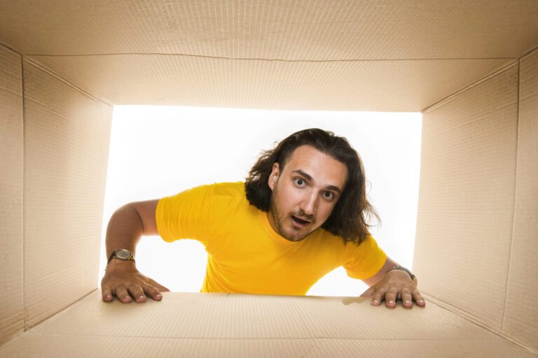 photo-of-man-looking-inside-a-box-surprised-when-renting-in-the-netherlands