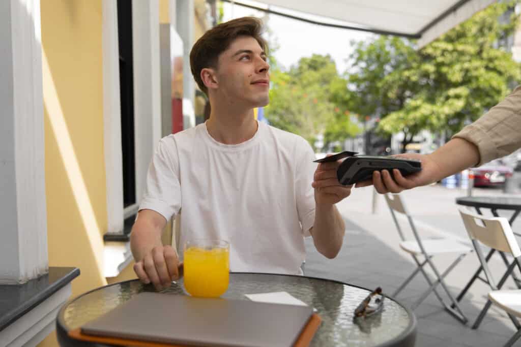 man-using-his-dutch-bank-card-to-pay-while-on-holiday-abroad
