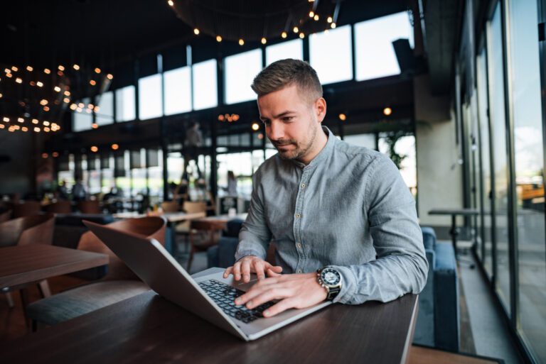 Man-using-a-vpn-on-his-laptop-in-a-cafe-in-the-netherlands