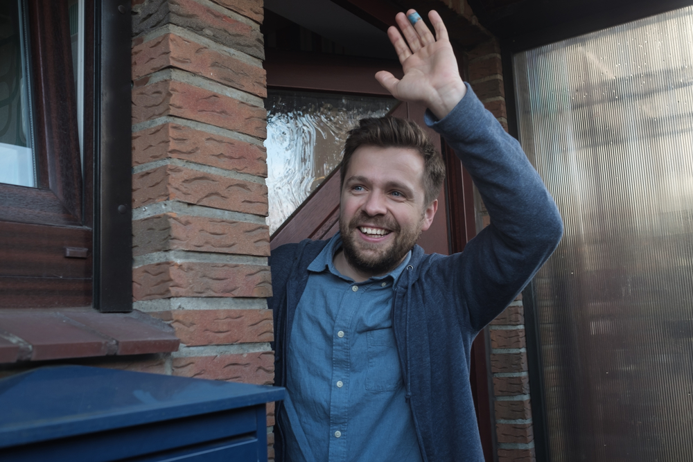 man-waving-hello-to-landlord-checking-his-antikraak-anti-squatting-property-in-the-Netherlands