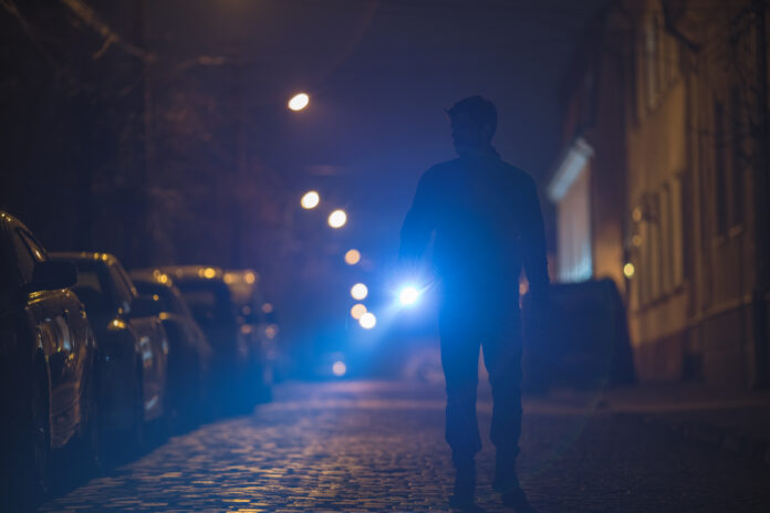 man-with-flashlight-inspect-street-evening-night-time