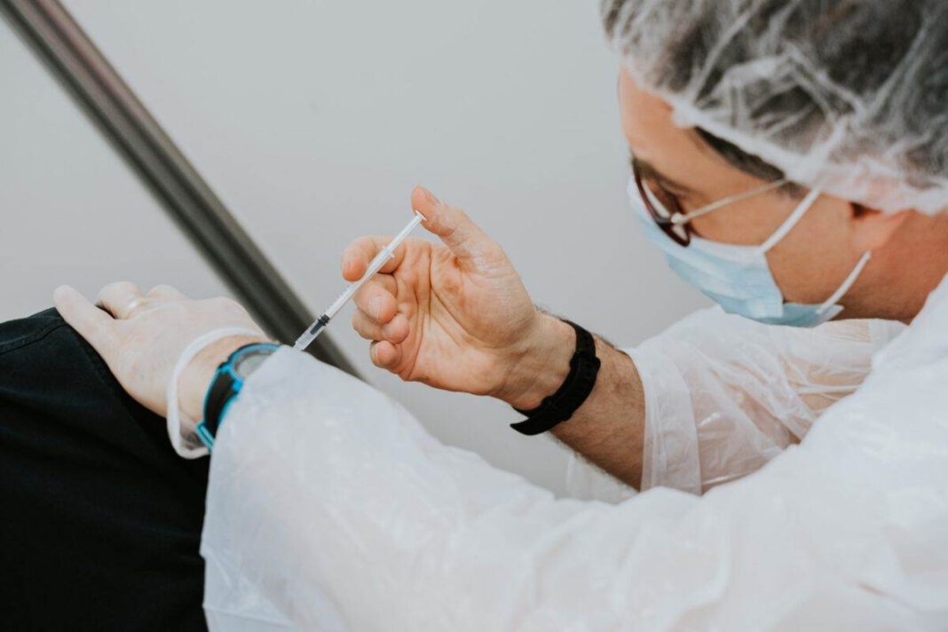 Doctor gives person a coronavirus vaccination
