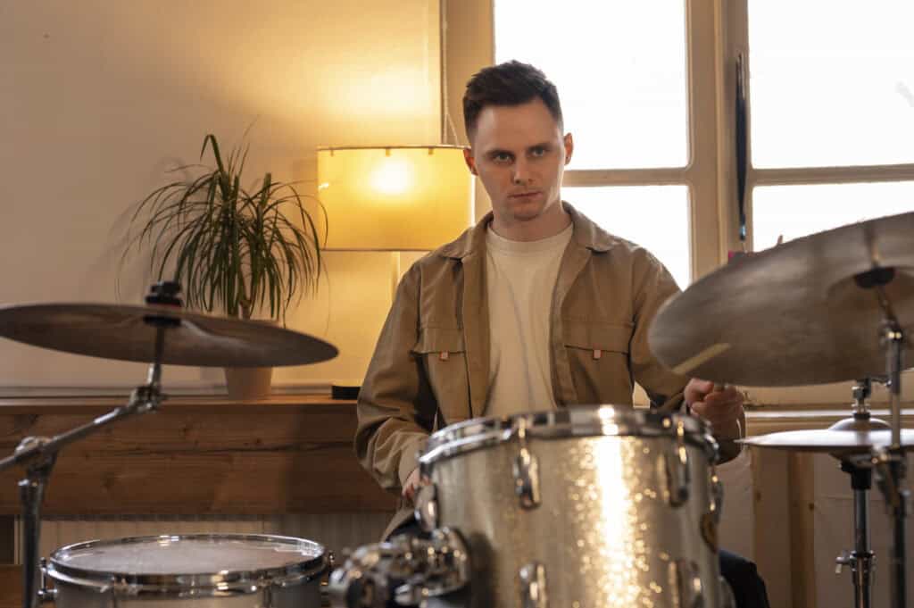 medium-shot-musician-practicing-drums-at-home