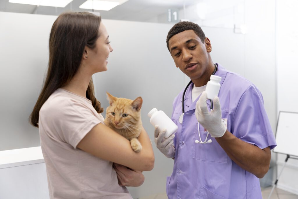 Vet-prescribing-medicine-to-woman-with-cat